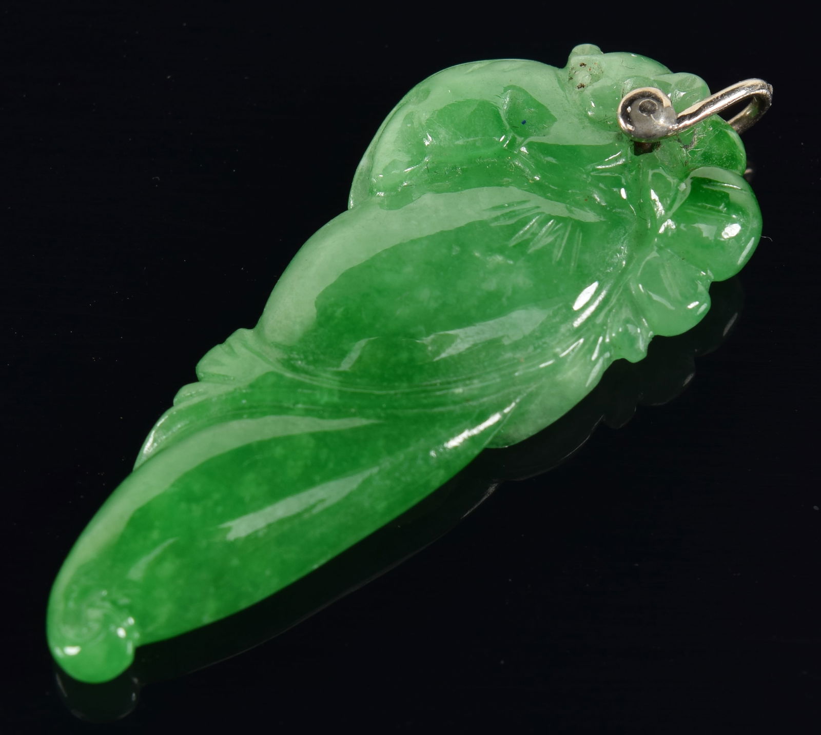 Jadeite pendant. Bright green color. Carved as a pepper with foliage. 1.5in length.: Jadeite pendant. Bright green color. Carved as a pepper with foliage. 1.5in length.