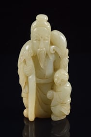 Jade carving. China. 19th century. Standing figure of Shao Lao with a child. 3.5in.