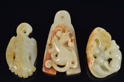 3 jade carvings. China. 19th/20th century. To include: a swan garment hook and 2 other pendants.