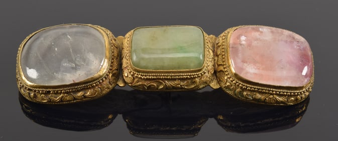 Gilt bronze buckle set with cabochons. China. 19th century. Mounted as a pin. 4in.