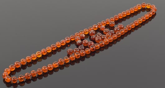 Strand of amber beads with additional beads from a separate set. 96.3 grams total weight.