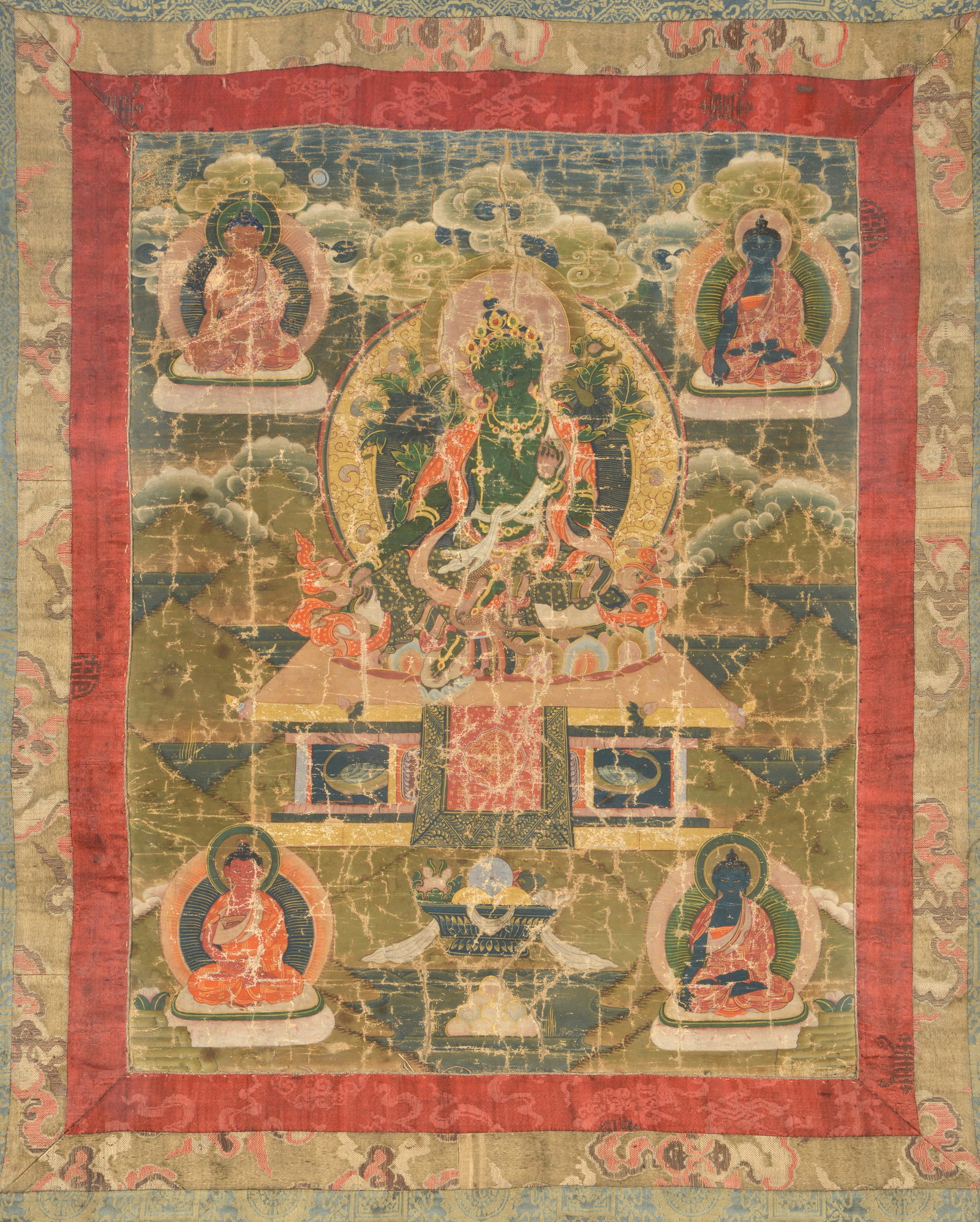 Buddhist icon. Tibet. 18th century. Thangka of ink, colors and gilt on heavy cloth. Green Tara with: Buddhist icon. Tibet. 18th century. Thangka of ink, colors and gilt on heavy cloth. Green Tara with lineage figures. 28 x 42in. Framed under glass.