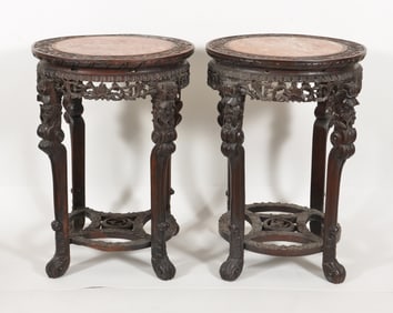 Pair of circular end tables. China. 19th century. Carved and pierced with floral elements. Inset red