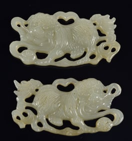 Pair of jade foo dogs with ribbons. China. 19th century. Each 2.25in length.