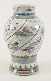 Famille verte vase. China. Late 19th century. Swirled design of a planting and flowers. Drilled.