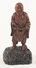 Carved wooden figure. China. 18th century. Figure of Liu Hai as a buddhist monk. Cloud carved base.