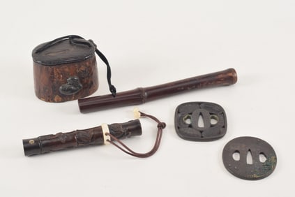 Lot of 4 Japanese items. 19th century. To include: 2 tsuba hand guards and 2 pipe cases.