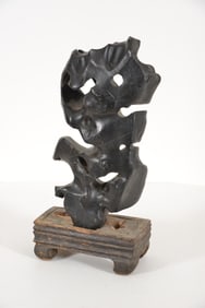 Scholar's rock. China. 19th century. Fitted wooden base. Lacquered surface. 18in high. Stand 4in.