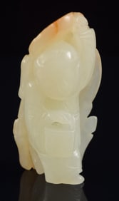 Jade little boy. China. 19th century. Pure white stone with russet markings. 2.5in length.