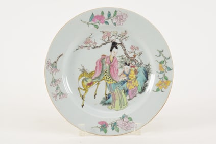 Porcelain plate. China. 19th century. Famille rose decoration of flowers, a woman with a child and