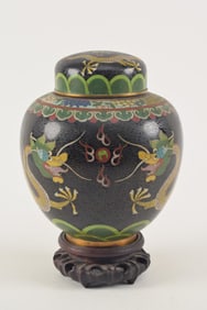 Cloisonne ginger jar and cover. China. Early 20th century. Decoration of dragons on a black ground.