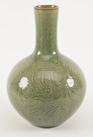 Porcelain vase. China. 20th century. Bottle form. Engraved with fish and lotus plants. Cracked