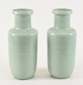 Pair of porcelain vases. China. 19th century. Rouleau form. Carved decoration beneath a celadon