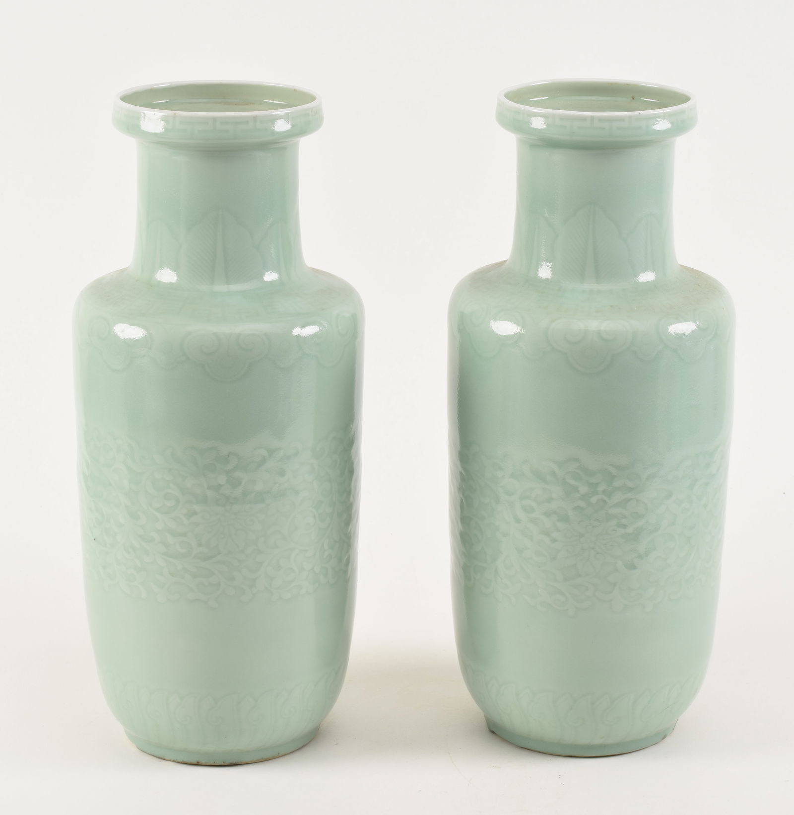 Pair of porcelain vases. China. 19th century. Rouleau form. Carved decoration beneath a celadon (1 of 9)