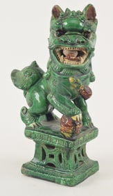 San Tsai foo dog. China. 19th century. Green and brown glaze. 12.75in.