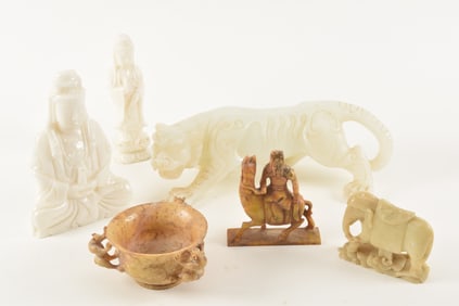 Lot of 6 soapstone carvings including a white tiger, elephant, figures of Kuan Yin, and more.