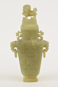Bowenite covered vase. China. 20th century. Lion finial. Archaic carved body. Provenance: From an