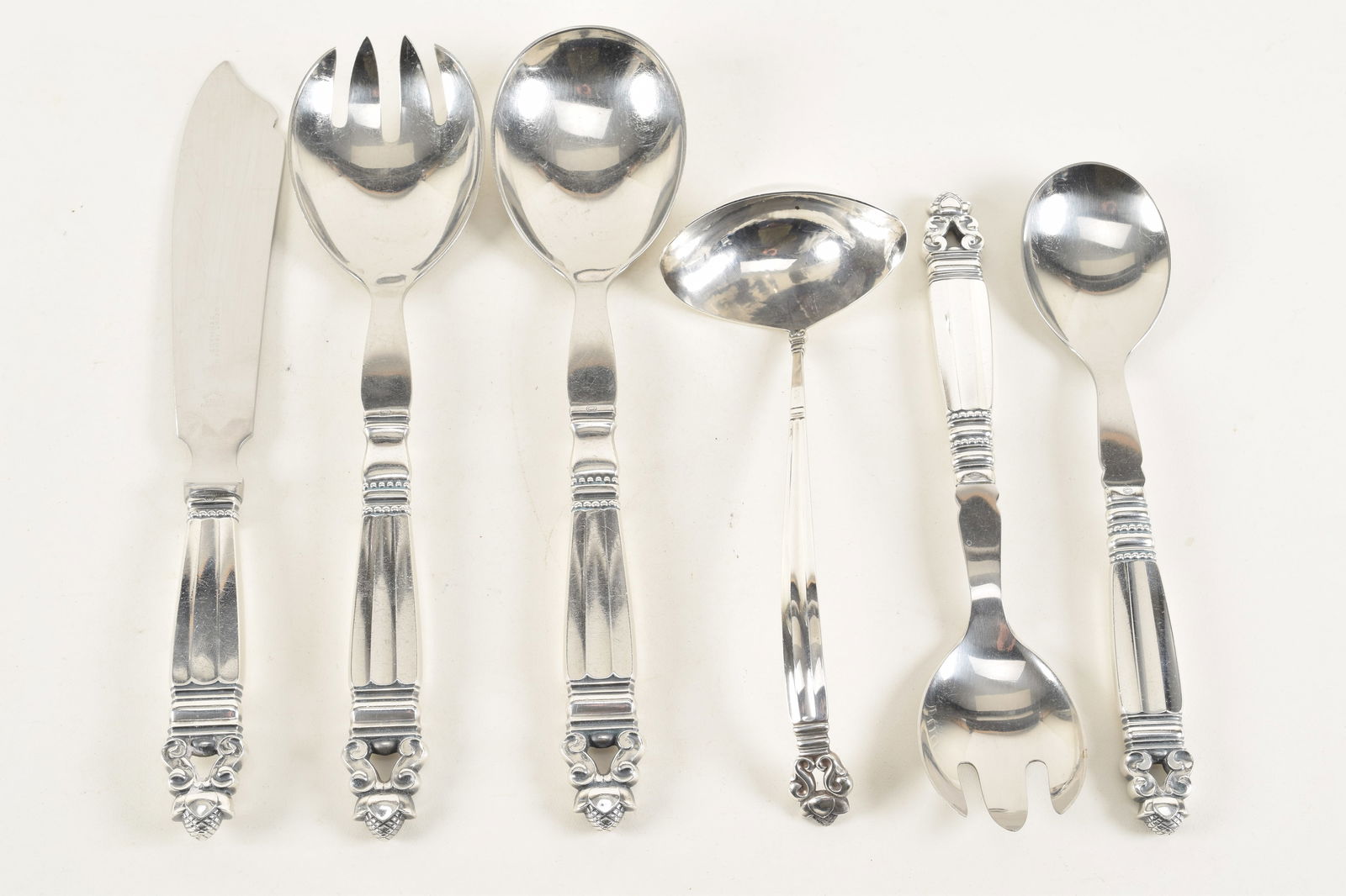 Georg Jensen "Acorn" sterling silver serving utensils. 2 sets of serving forks and spoons, a ladle, (1 of 4)