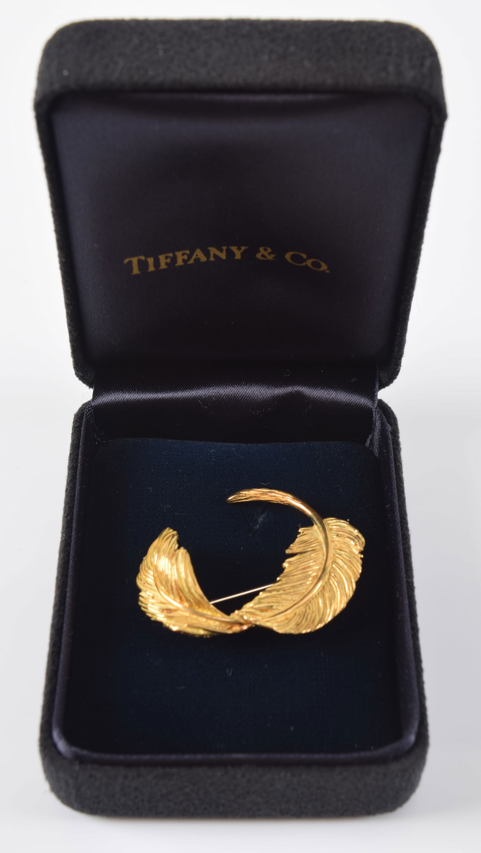 Tiffany & Co. 18K gold feather form pin. Marked 750 and maker's mark. 1.5in wide. 6.7 grams. (1 of 5)