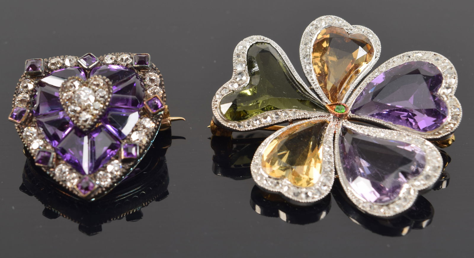 2 gold pins. To include: 1) Diamond and amethyst mounted heart shaped pin. Gold and silver setting. (1 of 3)