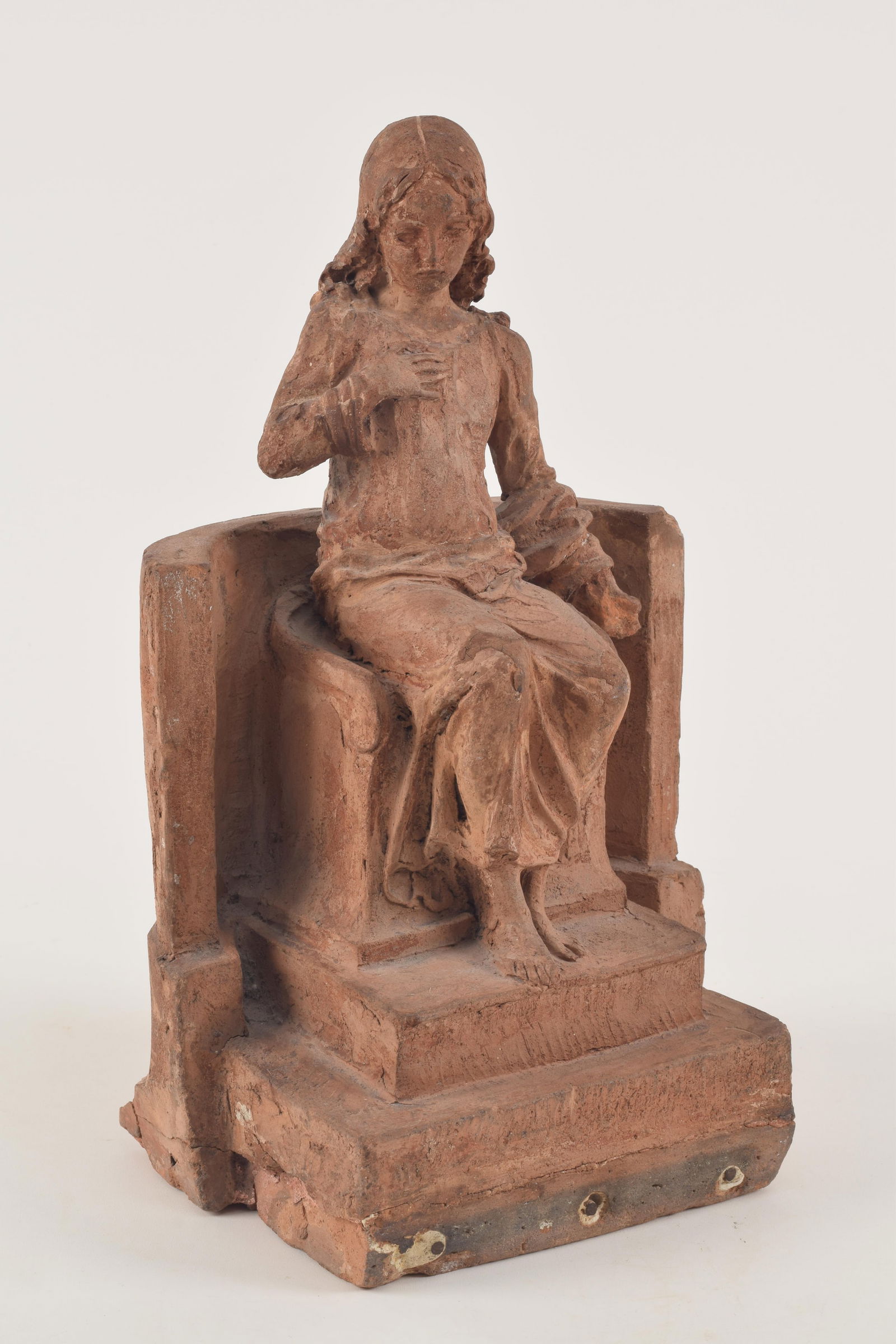 Early terracotta sculpture of a young child in robes seated on a chair. Possibly an artist's study. (1 of 7)
