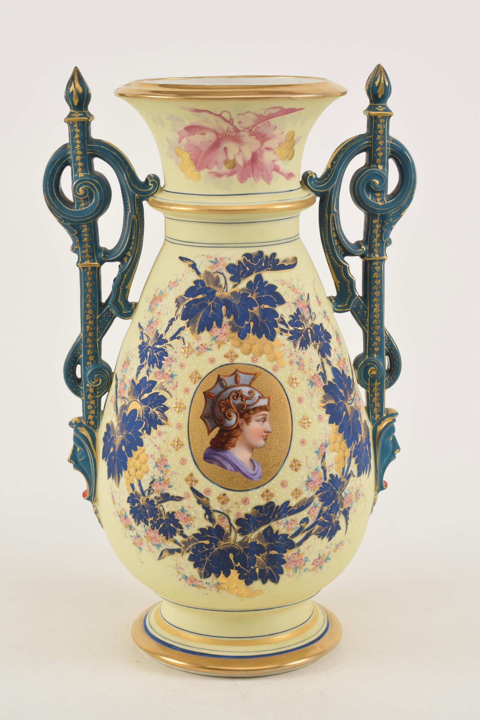 Large 19th century Paris porcelain ivory color ground vase with classical head medallion and grape: Large 19th century Paris porcelain ivory color ground vase with classical head medallion and grape vine garland decorations. Blue gilt mask head handles. Flake chip at top of 1 handle. tight spider cr