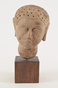 Carved stone head. China. Northern Ch'i style. 5th century AD. 10in high. Museum mount.