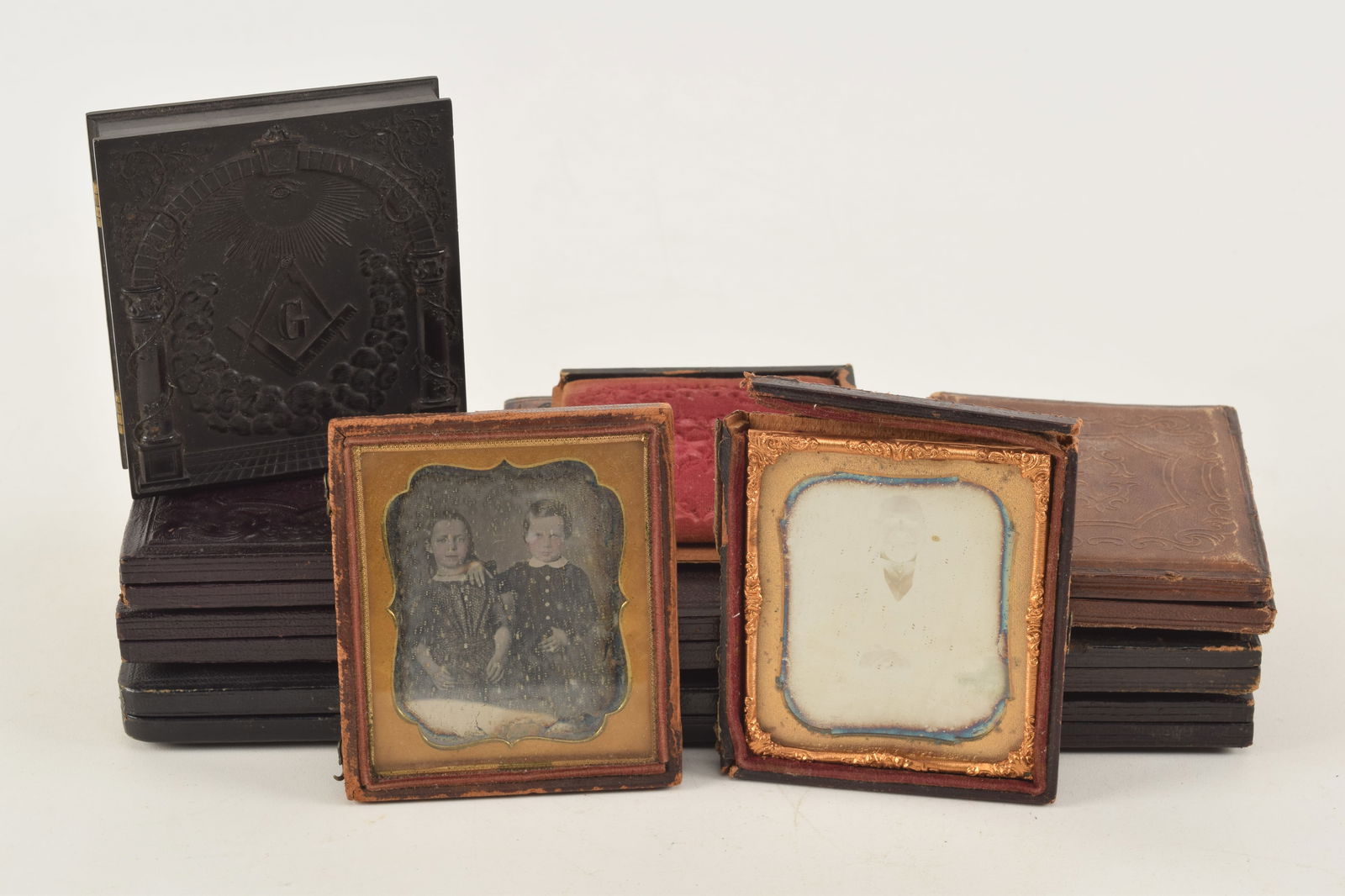 Lot of 10 daguerreotype photographs plus a black Masonic Union case. [2] 1/4 plate images: a fine (1 of 12)