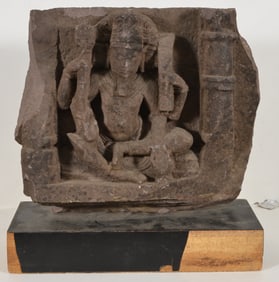 Carved stone image. India. 13th century. Granite. Seated figure of a Brahma. 16 x 16in.