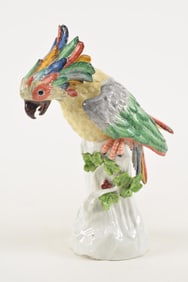 19th century porcelain parrot figurine. Colorful bird on branch. blue mark on rear near base. 11in