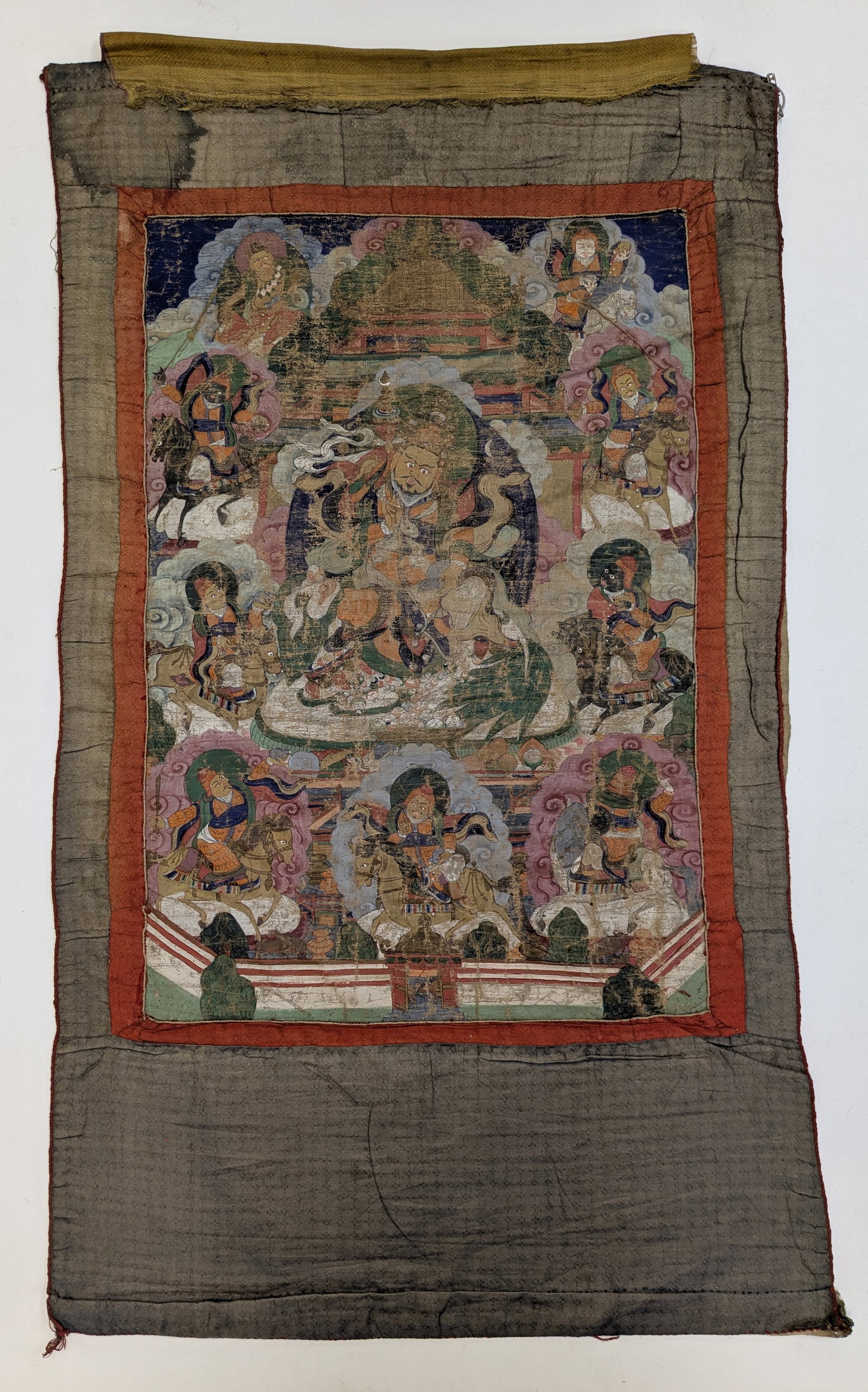 Buddhist icon. Tibet. 17th century. Thangka of Vaisravana with lineage figure. Ink and pigments on: Buddhist icon. Tibet. 17th century. Thangka of Vaisravana with lineage figure. Ink and pigments on cloth. Image: 25.75 x 17.5in. Wear consistent with age.