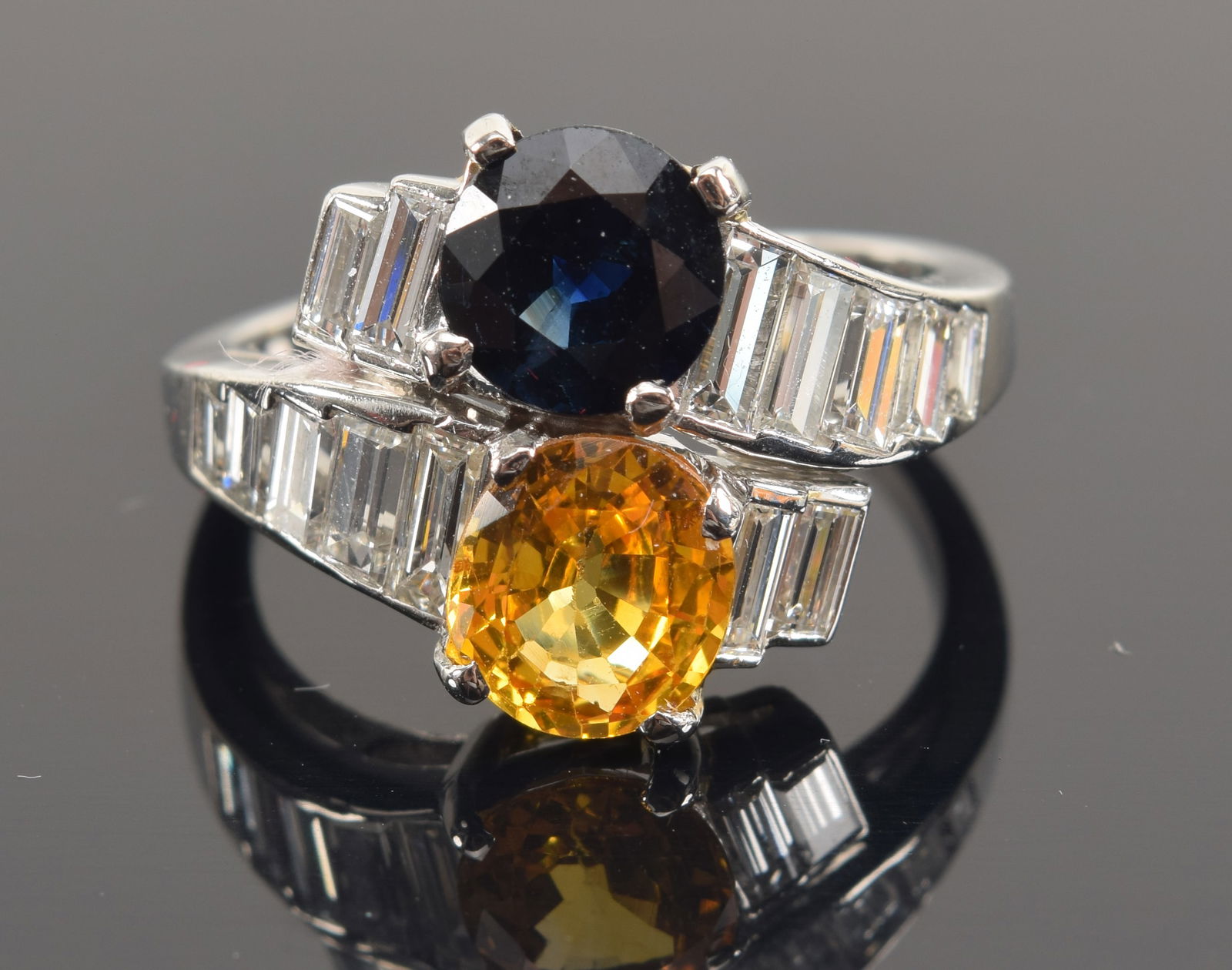 Platinum blue and yellow natural sapphire mounted bypass ring. Blue sapphire: 1.3 CT., round faceted (1 of 8)