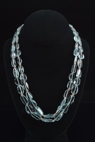 Designer 18K gold sapphire and diamond mounted dual strand necklace of polished semi-precious aqua