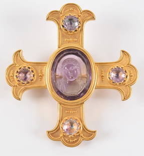 Attributed to Castellani 22K gold carved amethyst cross form brooch. Central relief: Attributed to Castellani 22K gold carved amethyst cross form brooch. Central relief carved amethyst stone with an image of the Virgin Mary. flanked by 4 round cut amethyst stones. Unmarked.