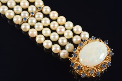 Designer 14K gold 4-strand pearl bracelet with large opal and sapphire mounted clasp. Elevated large