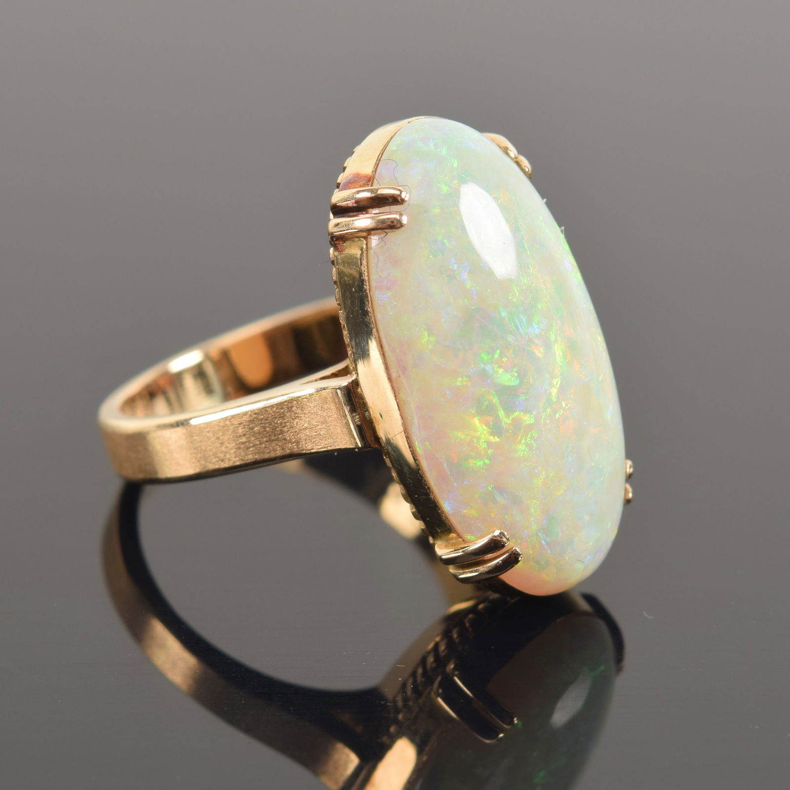 Vintage 18K gold opal mounted ring. Large oval opal measuring 21.1 x 11.2mm. Marked 18K and other (1 of 6)