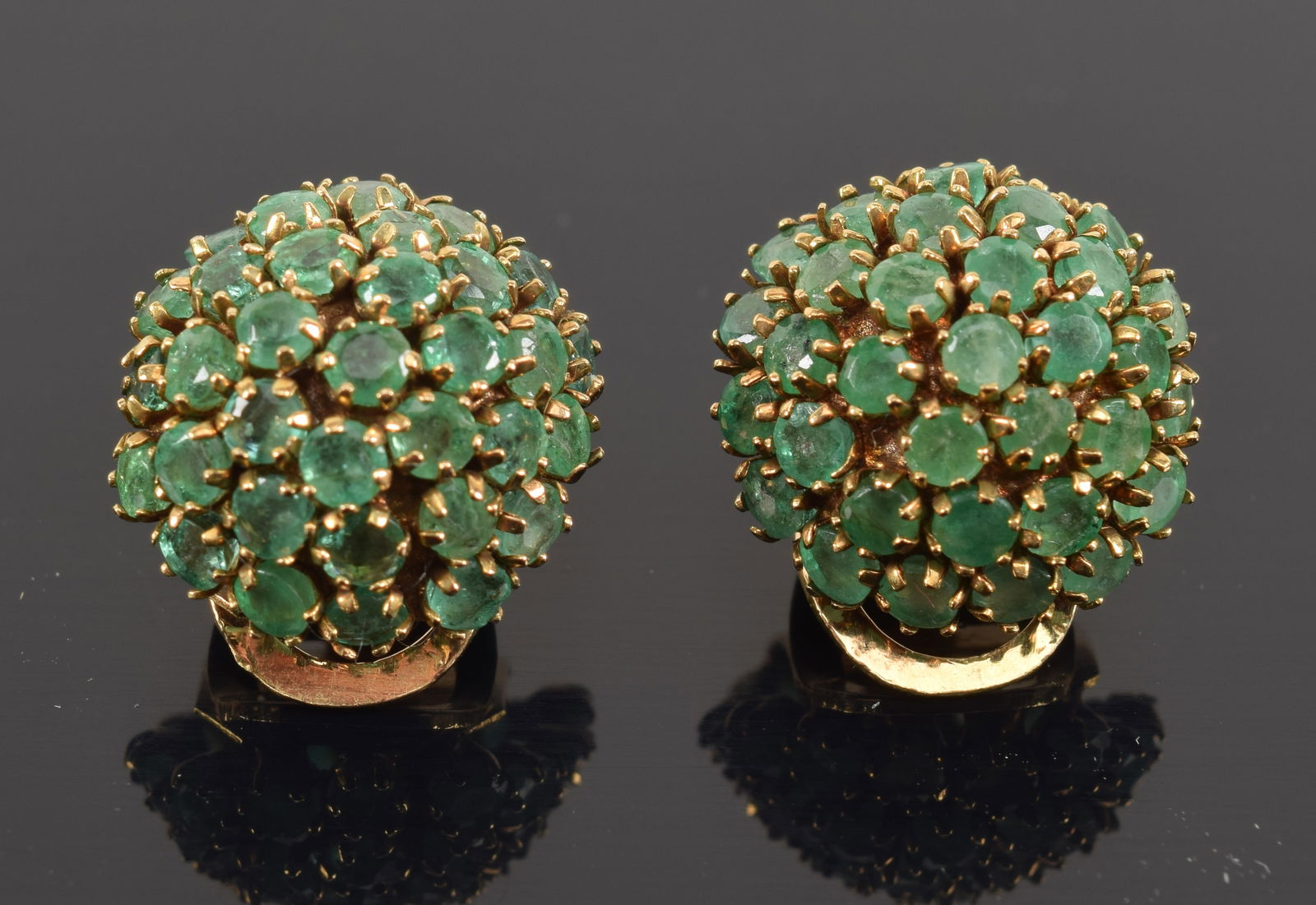 Vintage 14K gold emerald mounted earrings. Domed form. Emeralds about 2.2mm diameter each. Marked: Vintage 14K gold emerald mounted earrings. Domed form. Emeralds about 2.2mm diameter each. Marked 14. 0.75in diameter. 5.5 grams.