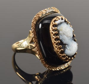 Vintage 14K gold onyx cameo ring. Black ground cameo with gold mounts on large onyx base. Marked