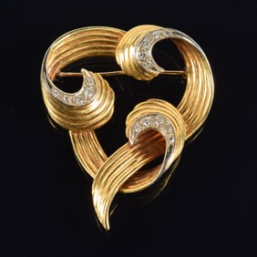 Vintage 18K gold diamond mounted pin. Heavy interlaced open swirl design set with 3 channels of
