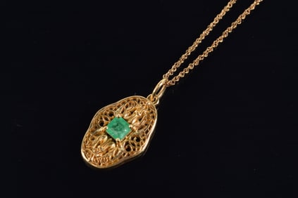 14K gold emerald mounted pendant necklace. Openwork pendant with square cut emerald measuring 4.8 x