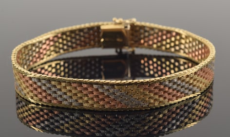 14K tri-color gold bracelet. Design of alternating diagonal bands of white, yellow and rose gold.