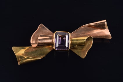 Spaulding 14K rose and yellow gold amethyst mounted ribbon form pin. Marked 14K. Amethyst: 9.7 x