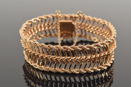 Heavy 14K gold openwork bracelet with rope twist borders and interior herringbone design. Opening