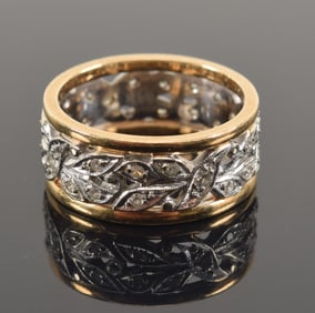 14K white and yellow gold diamond mounted eternity ring. Reticulated foliate decoration set with