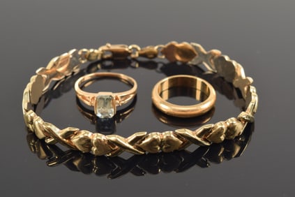 Lot of gold jewelry. 1) 10K gold heart and cross pattern bracelet. 7.25in length. 5.2 grams. 2) 14K