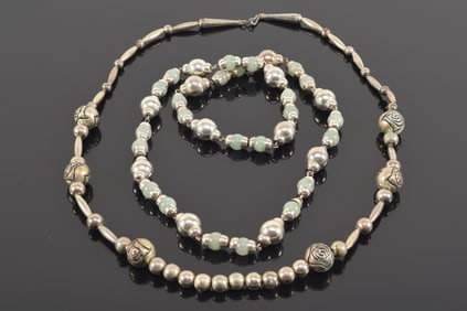 2 silver necklaces. 1) Silver and green stone bead necklace. Does not appear to have a clasp by