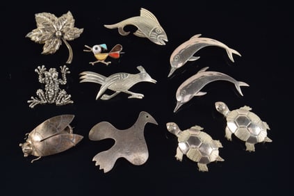 Lot of figural sterling silver pins to include: Taxco cicada, turtles, dolphins, etc. Most marked