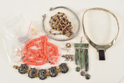 Lot of assorted jewelry items. To include: vintage Egyptian revival bracelet, sterling silver bear