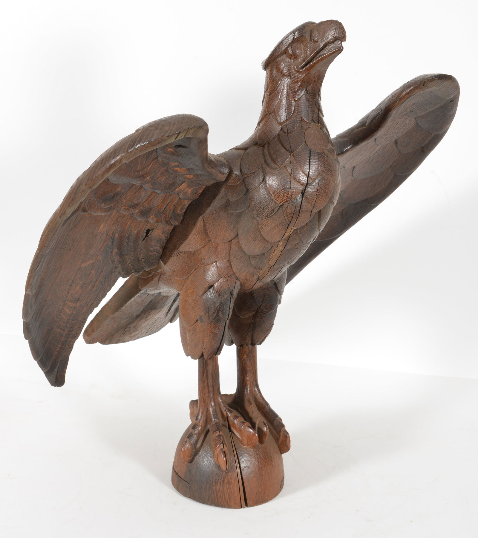 Carved oak full bodied eagle with spread wings, ca 1900. One wing is an old replacement. Age cracks (1 of 8)