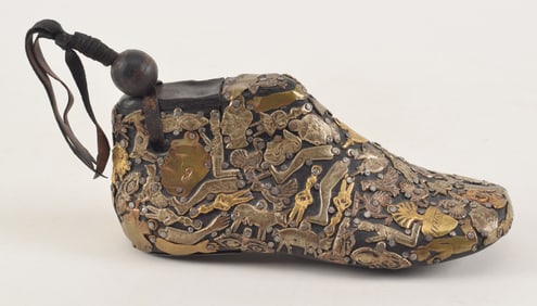 Antique Mexican folk art milagro charm studded shoe form. 7in length.